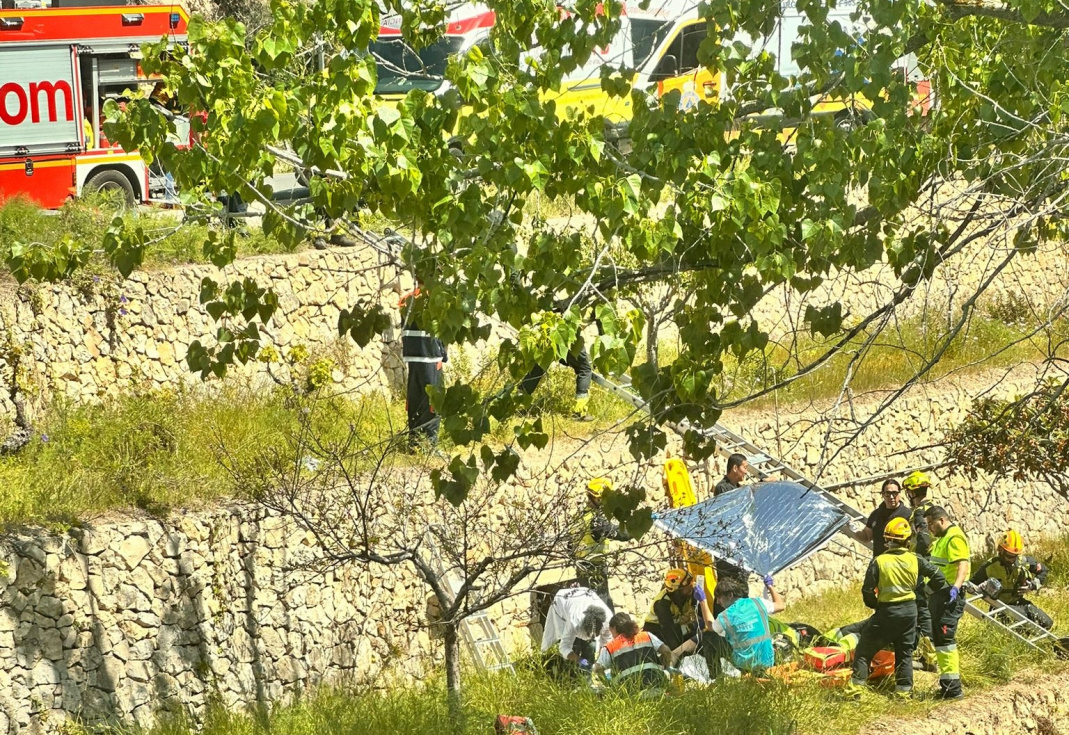 Efectivos de emergencias atienden al herido en la zona de bancales tras la ca&iacute;da.
